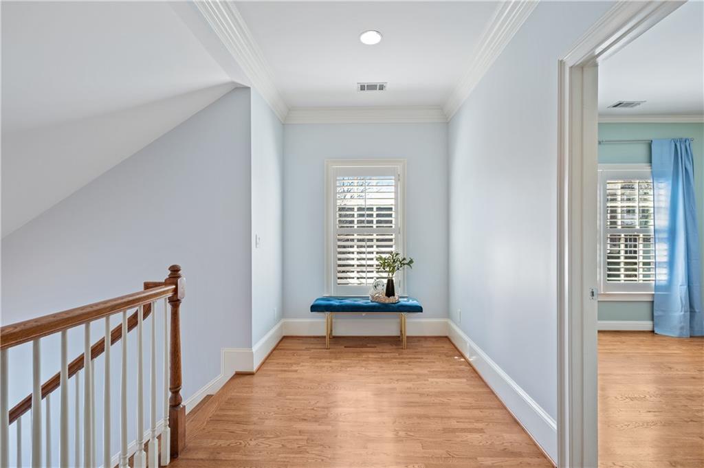 932 Manor Parc Drive Decatur, GA 30033 - Photo 16 of 38 a view of a hallway to an empty room with wooden floor and a window