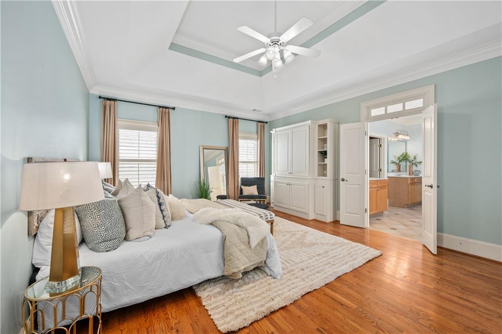 932 Manor Parc Drive Decatur, GA 30033 - Photo 18 of 38 a spacious bedroom with a large bed a chandelier and windows