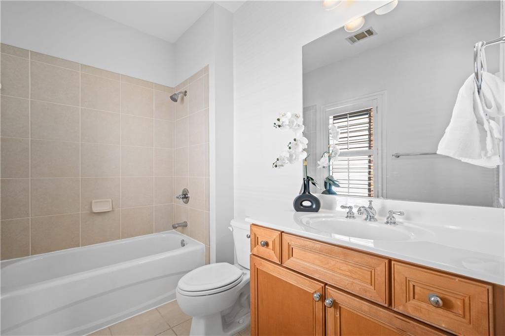 932 Manor Parc Drive Decatur, GA 30033 - Photo 27 of 38 a bathroom with a granite countertop sink a toilet a mirror a bathtub and shower