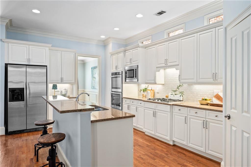 932 Manor Parc Drive Decatur, GA 30033 - Photo 8 of 38 a kitchen with stainless steel appliances kitchen island granite countertop a sink and refrigerator