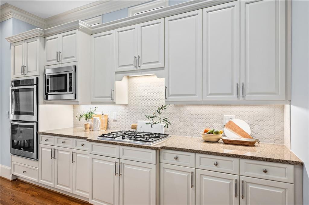 932 Manor Parc Drive Decatur, GA 30033 - Photo 9 of 38 a kitchen with stainless steel appliances granite countertop white cabinets a sink and dishwasher
