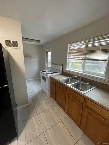 a kitchen that has a sink and a stove