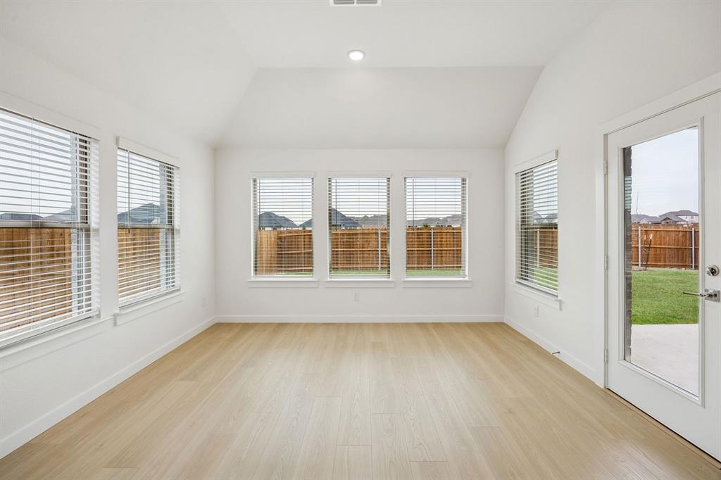 348 Yellowstar Lane Lavon, TX 75166 - Photo 11 of 39 an empty room with wooden floor and windows