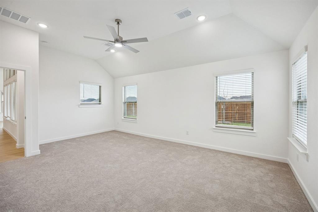 348 Yellowstar Lane Lavon, TX 75166 - Photo 17 of 39 en empty room with windows and ceiling fan
