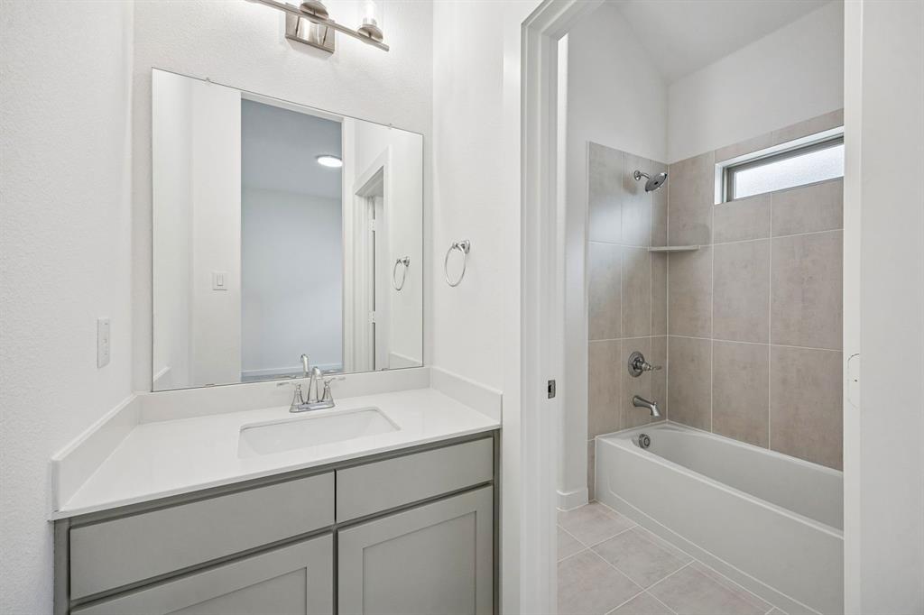 348 Yellowstar Lane Lavon, TX 75166 - Photo 27 of 39 a bathroom with a tub sink shower and mirror