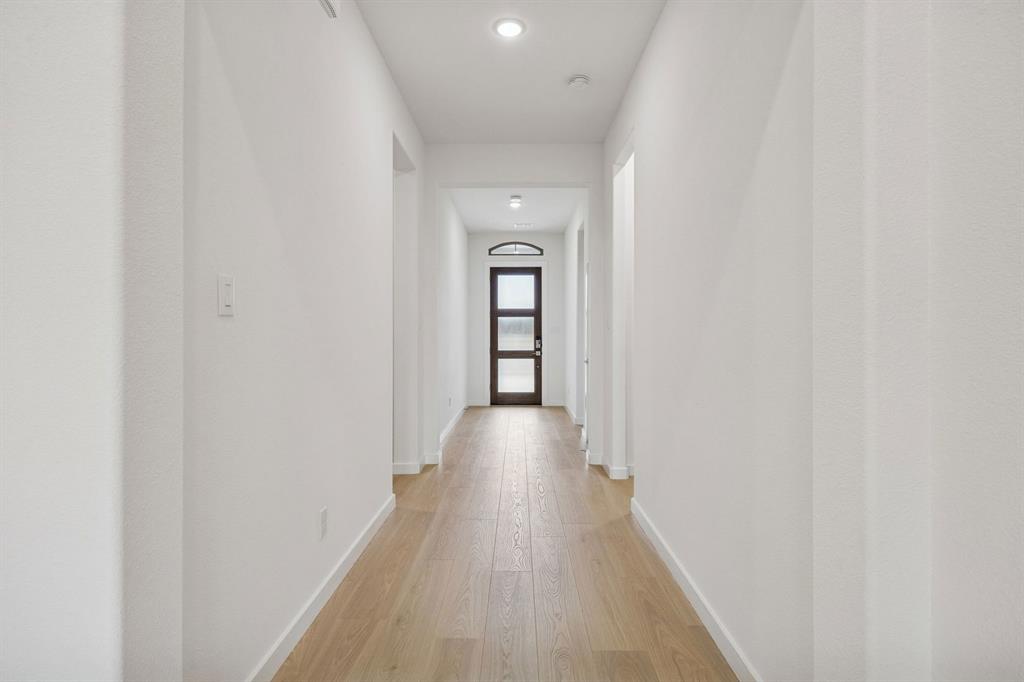 348 Yellowstar Lane Lavon, TX 75166 - Photo 32 of 39 a view of a hallway with wooden floor and staircase