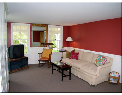 168 Argilla Road Ipswich, MA 01938 - Photo 19 of 27 a living room with furniture and a flat screen tv