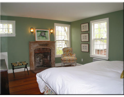 168 Argilla Road Ipswich, MA 01938 - Photo 20 of 27 a bedroom with a bed and a fireplace