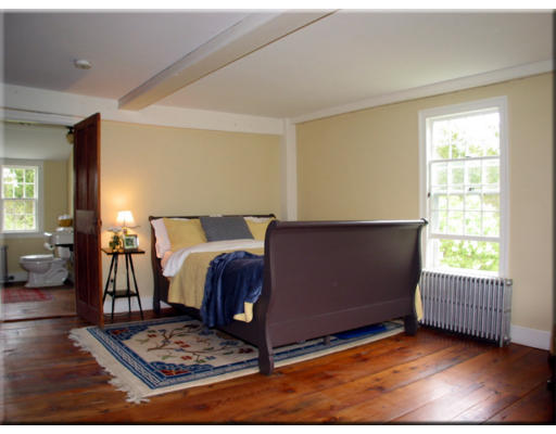 168 Argilla Road Ipswich, MA 01938 - Photo 22 of 27 a living room with a couch and a table with wooden floor