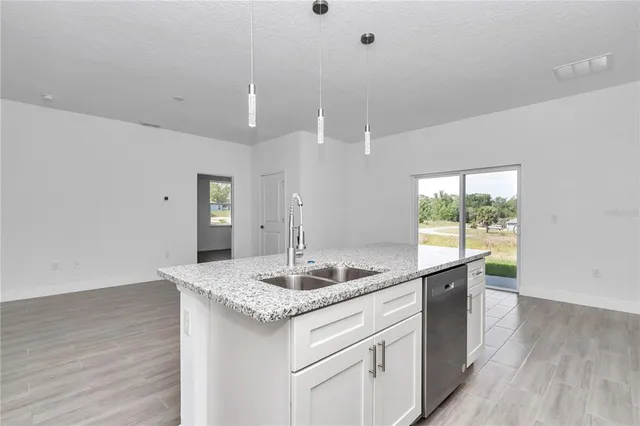 a view of a room that has wooden floor and a window