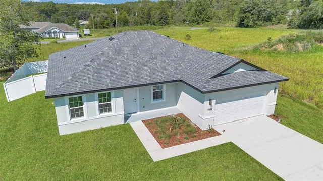 a front view of a house with a garden and yard