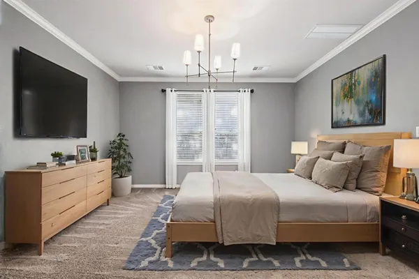 a bedroom with a large bed and a flat screen tv