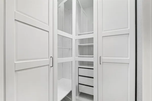 a view of walk in closet with empty racks