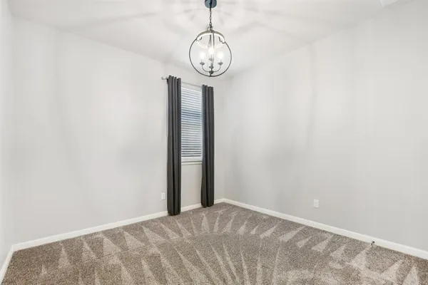a view of a hallway with a wall clock and a window