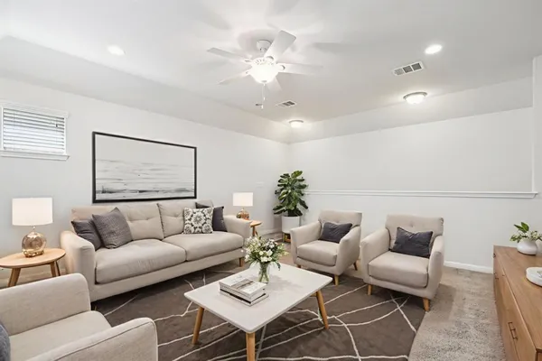 a living room with furniture and a chandelier