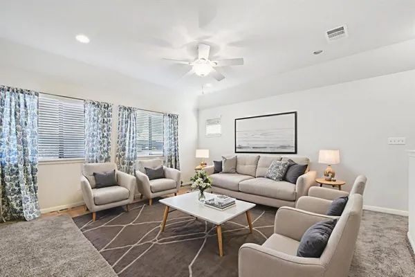 a living room with furniture a table and a large window