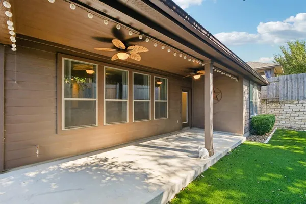 a view of house with backyard and glass windows