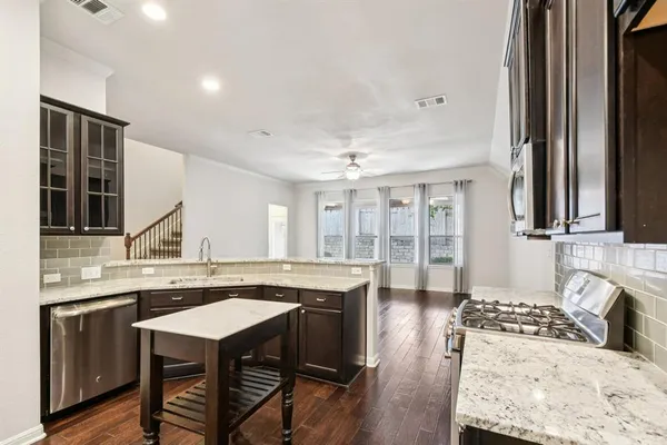 a kitchen with a stove a sink and a refrigerator