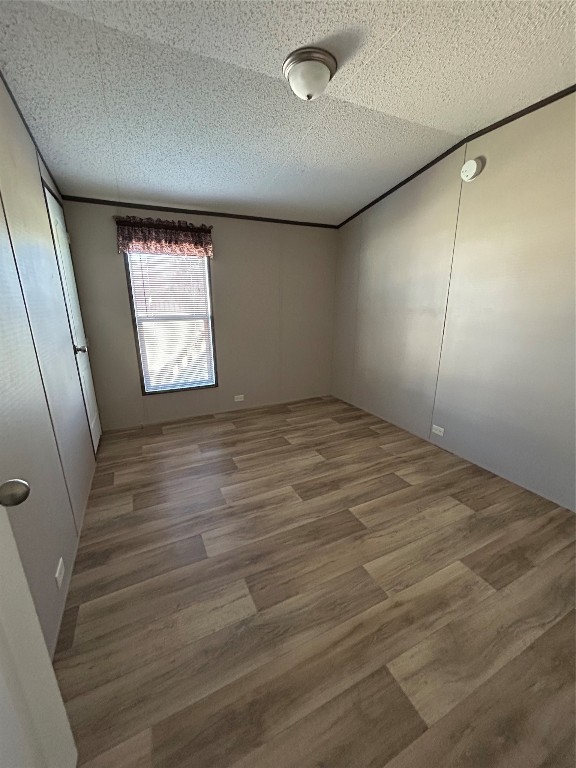 19130 Fm 1485 Road, Unit 153 New Caney, TX 77357 - Photo 6 of 9 an empty room with wooden floor and windows