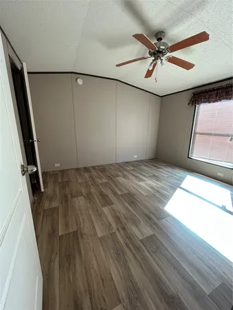 a view of a hallway with a ceiling fan