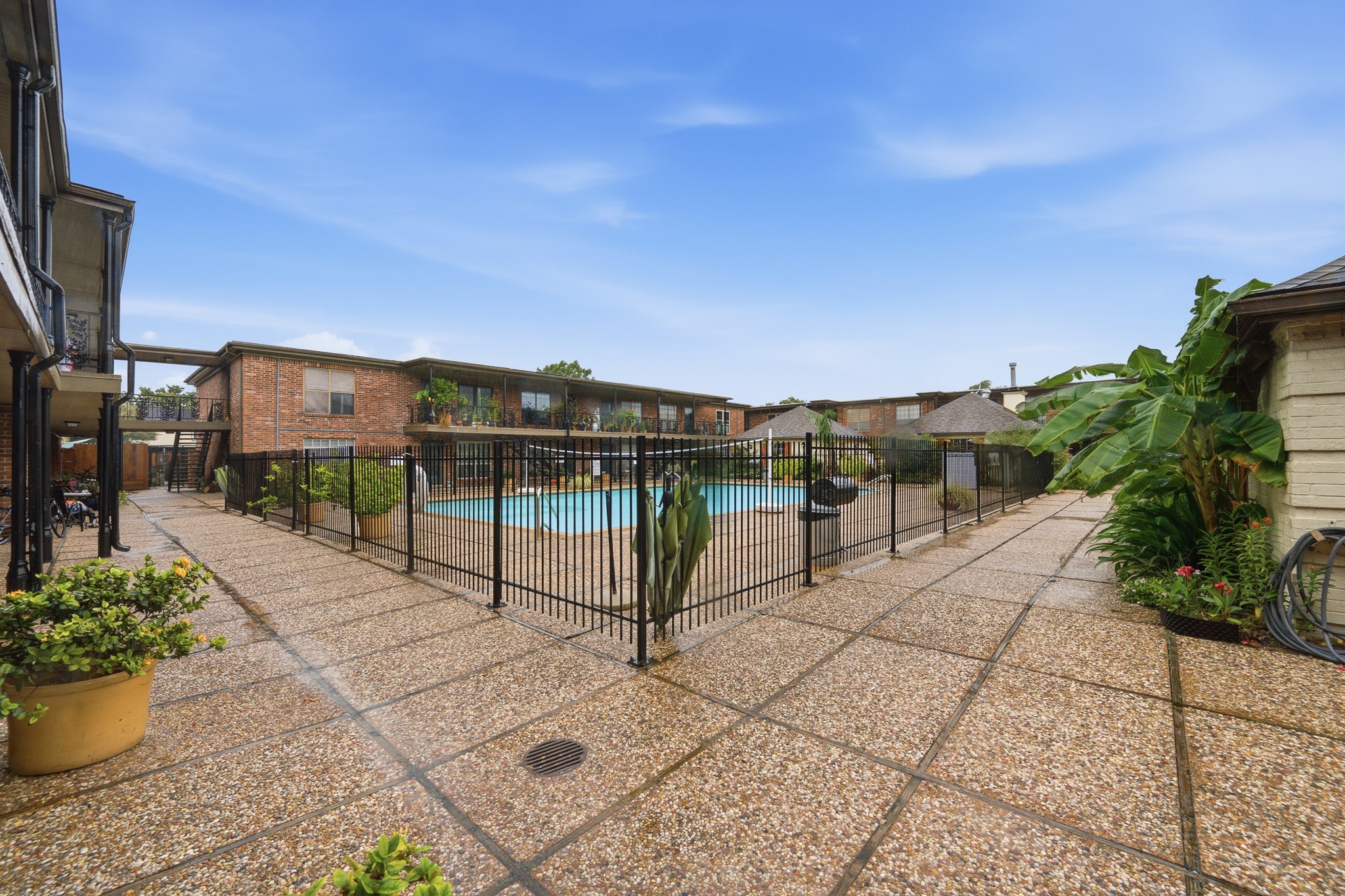 11550 Chimney Rock Road, Unit 133 Houston, TX 77035 - Photo 33 of 40 Beautiful courtyard with a sparkling pool, surrounded by well-maintained pathways and lush greenery, perfect for relaxation and outdoor enjoyment.