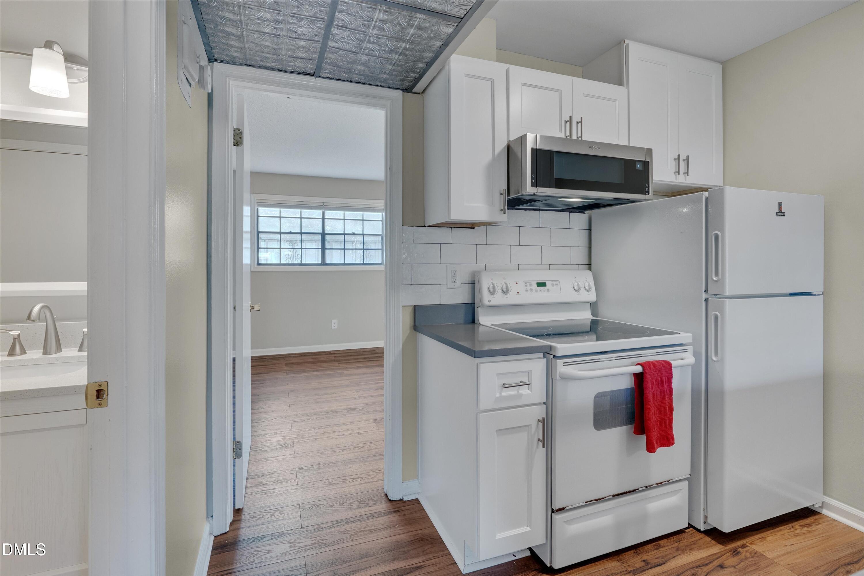 807 West Trinity Avenue, Unit 130 Durham, NC 27701 - Photo 20 of 44 a kitchen with stainless steel appliances granite countertop a stove and a refrigerator