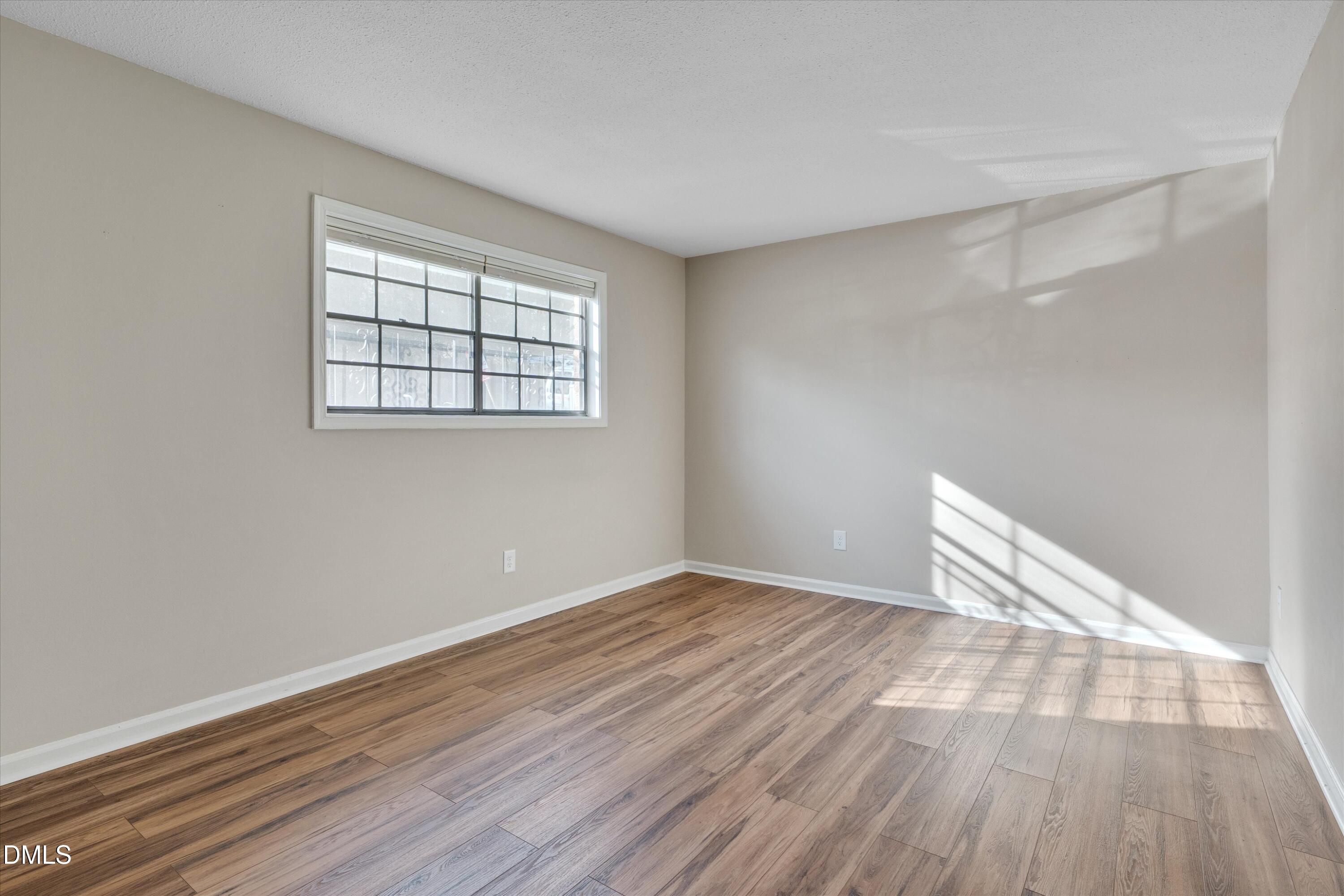 807 West Trinity Avenue, Unit 130 Durham, NC 27701 - Photo 22 of 44 wooden floor in an empty room with a window