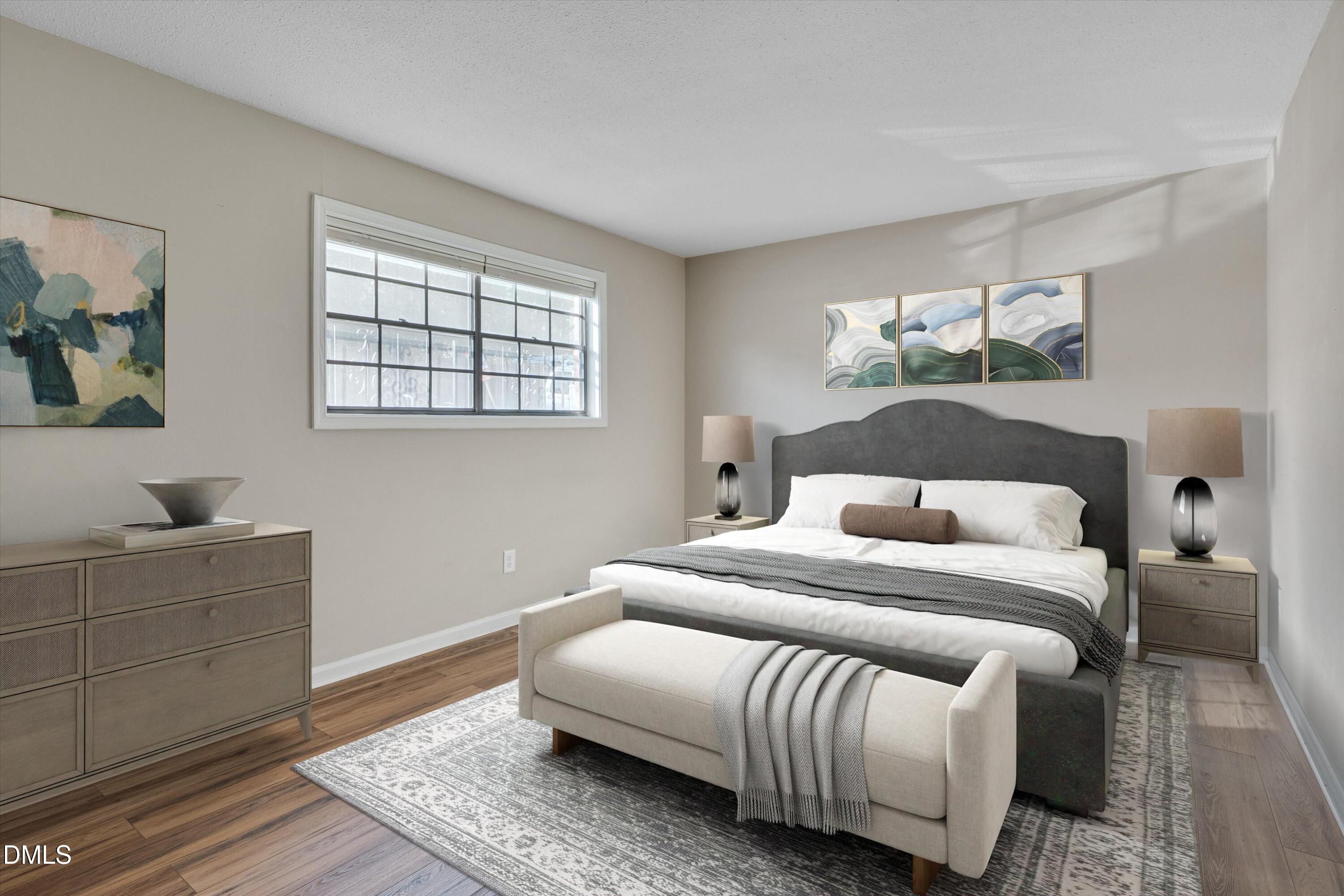 807 West Trinity Avenue, Unit 130 Durham, NC 27701 - Photo 3 of 44 a bedroom with a bed and wooden floor