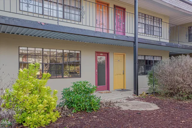 a view of a house with brick walls and a yard