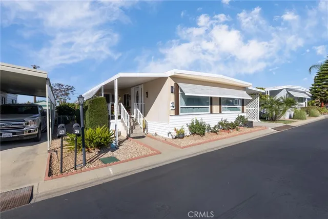 a front view of house with yard and car parked