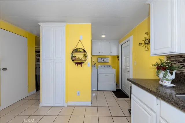 a utility room with a sink and cabinets