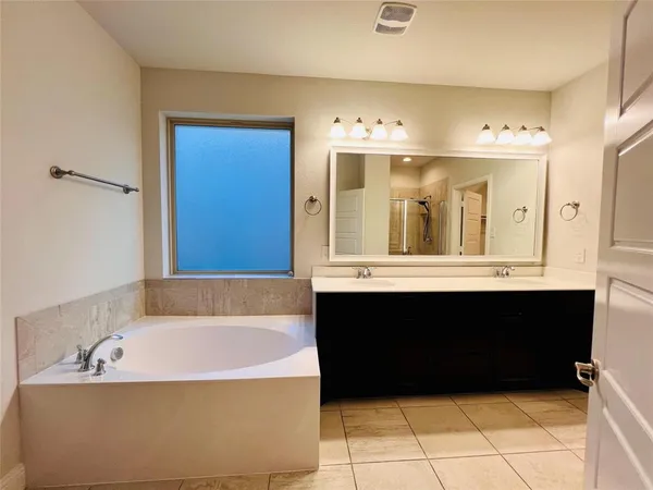 a bathroom with a bathtub and a sink