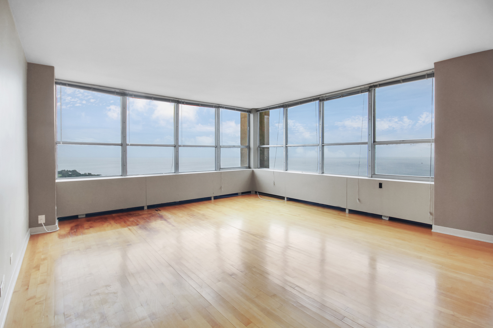 655 West Irving Park Road, Unit 5310 Chicago, IL 60613 - Photo 12 of 21 an empty room with wooden floor and windows