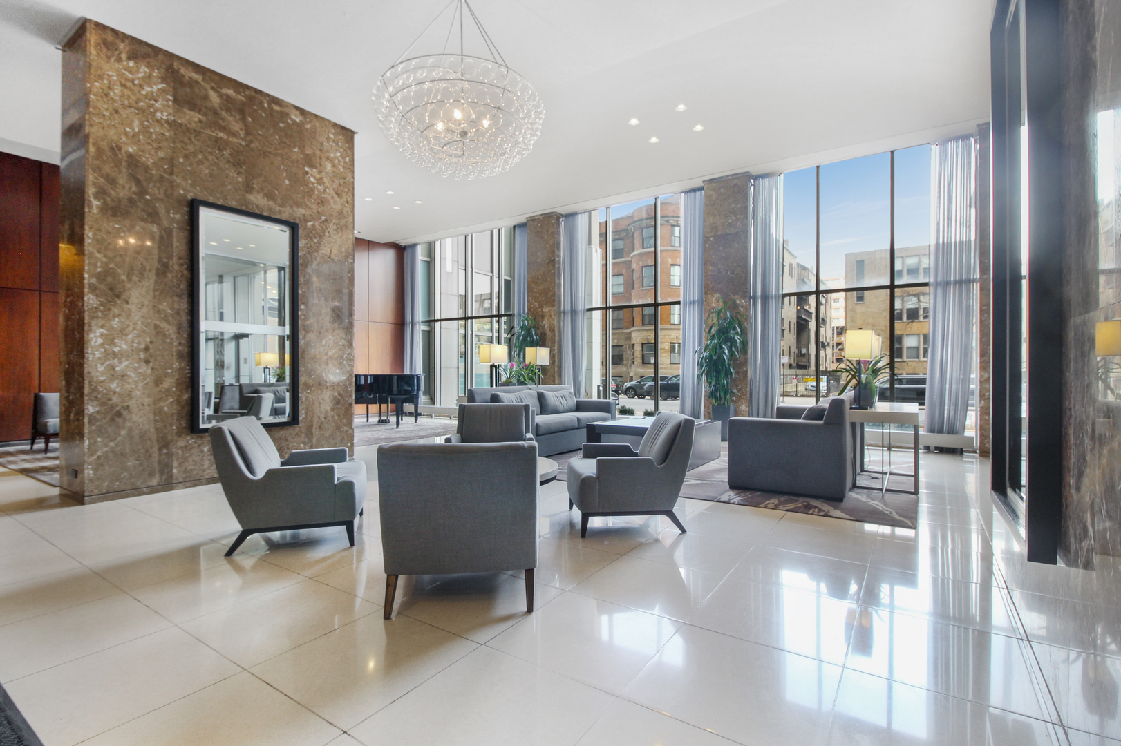 655 West Irving Park Road, Unit 5310 Chicago, IL 60613 - Photo 8 of 21 a living room with furniture a large window and stainless steel appliances