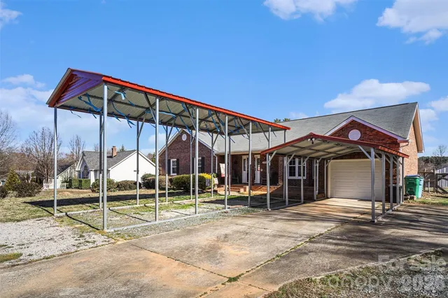 a view of a chair and table in backyard of the house