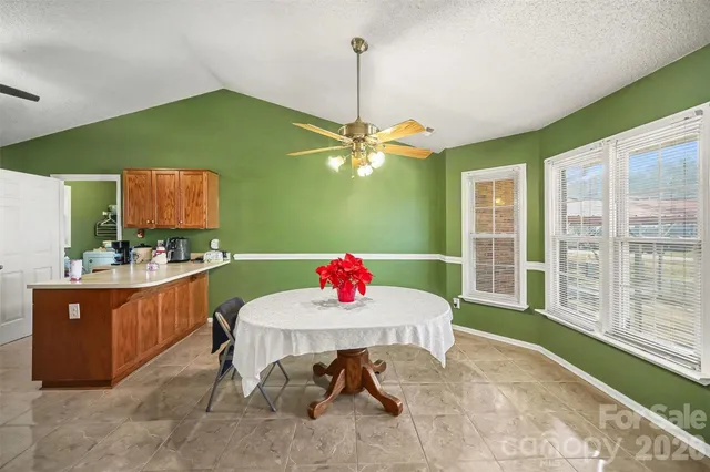 a dining room with a table and chairs