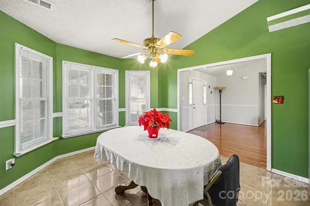 a view of a dining room with furniture and a chandelier