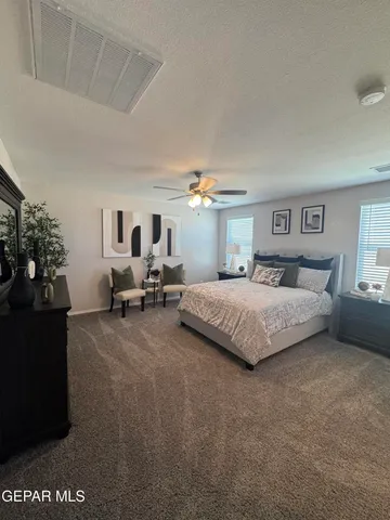 a bedroom with a bed and dresser