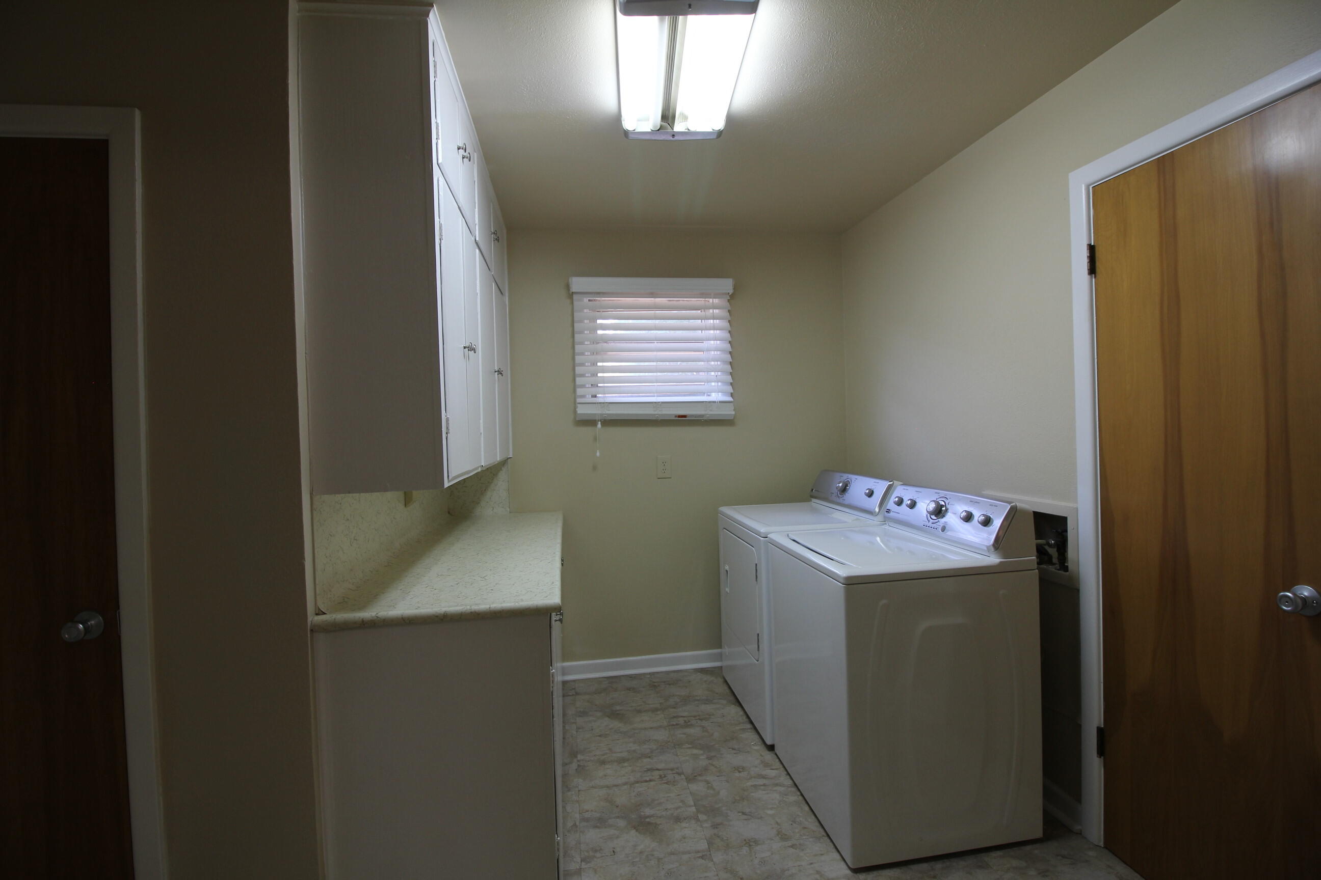 2208 32nd Street Lubbock, TX 79411 - Photo 13 of 14 a utility room with closet and window