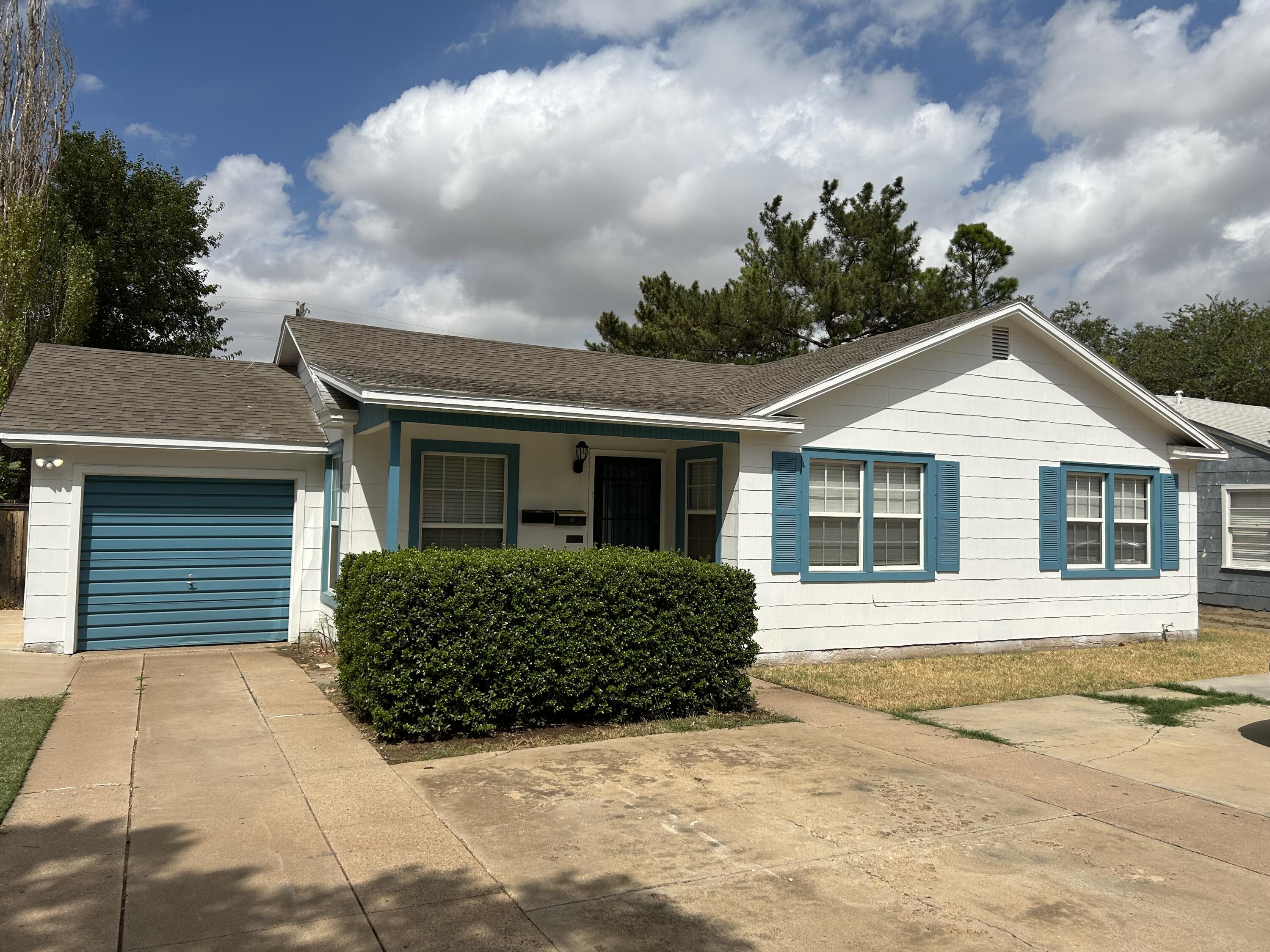 2208 32nd Street Lubbock, TX 79411 - Photo 2 of 14 a front view of a house with a yard and garage