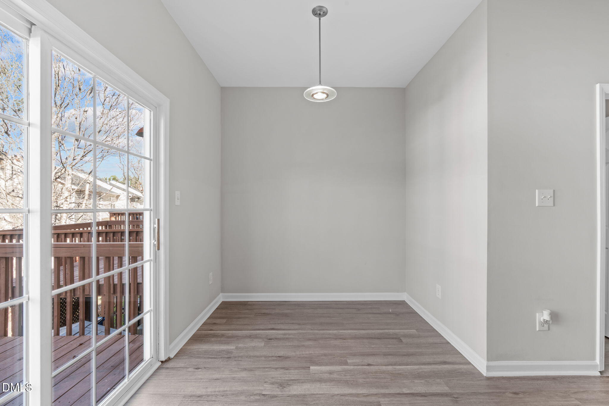 5505 Crabtree Park Court Raleigh, NC 27612 - Photo 13 of 30 a view of an empty room with wooden floor and a window