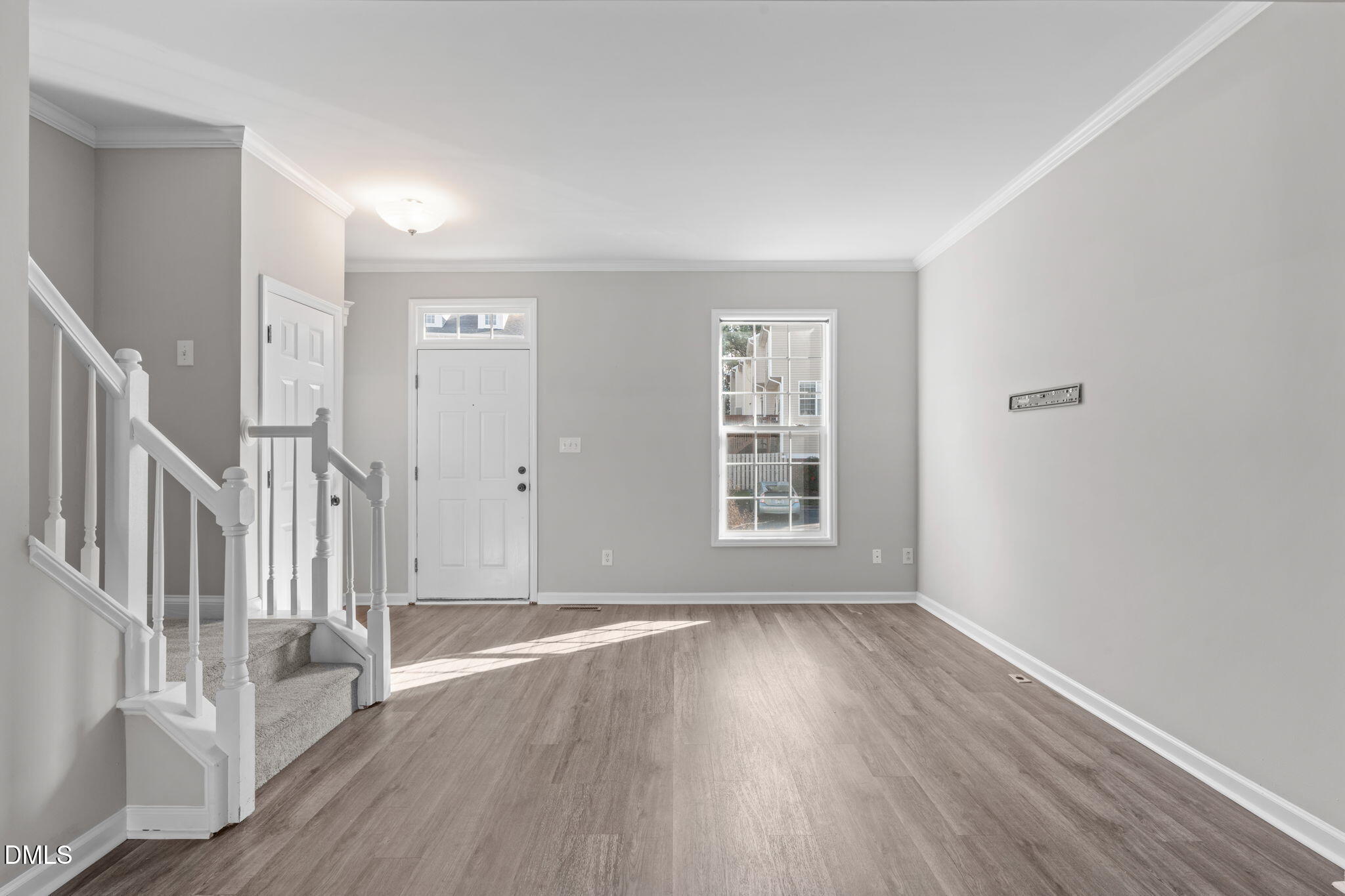 5505 Crabtree Park Court Raleigh, NC 27612 - Photo 9 of 30 a view of an empty room with wooden floor and a window