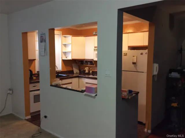a kitchen with a sink refrigerator and window
