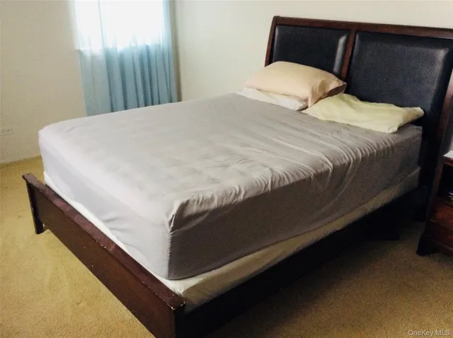 a bedroom with bed and window