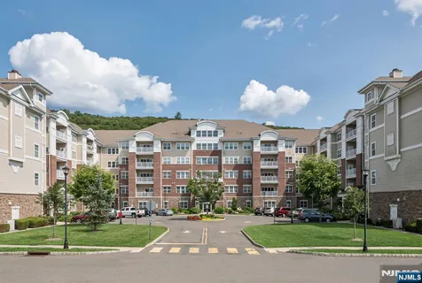 a front view of building with yard