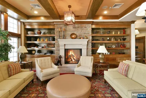 a living room with furniture a fireplace and a table