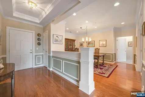 a open kitchen with cabinets wooden floor and stainless steel appliances