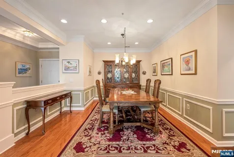 a dining room with wooden floor and furniture