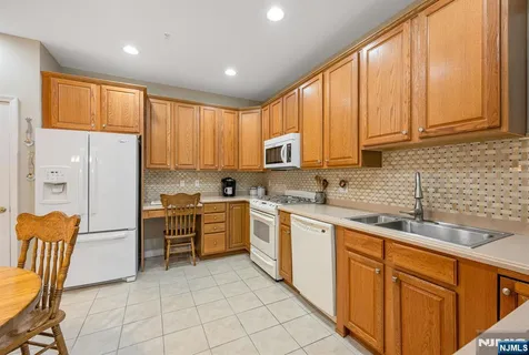a kitchen with stainless steel appliances granite countertop a refrigerator sink and cabinets