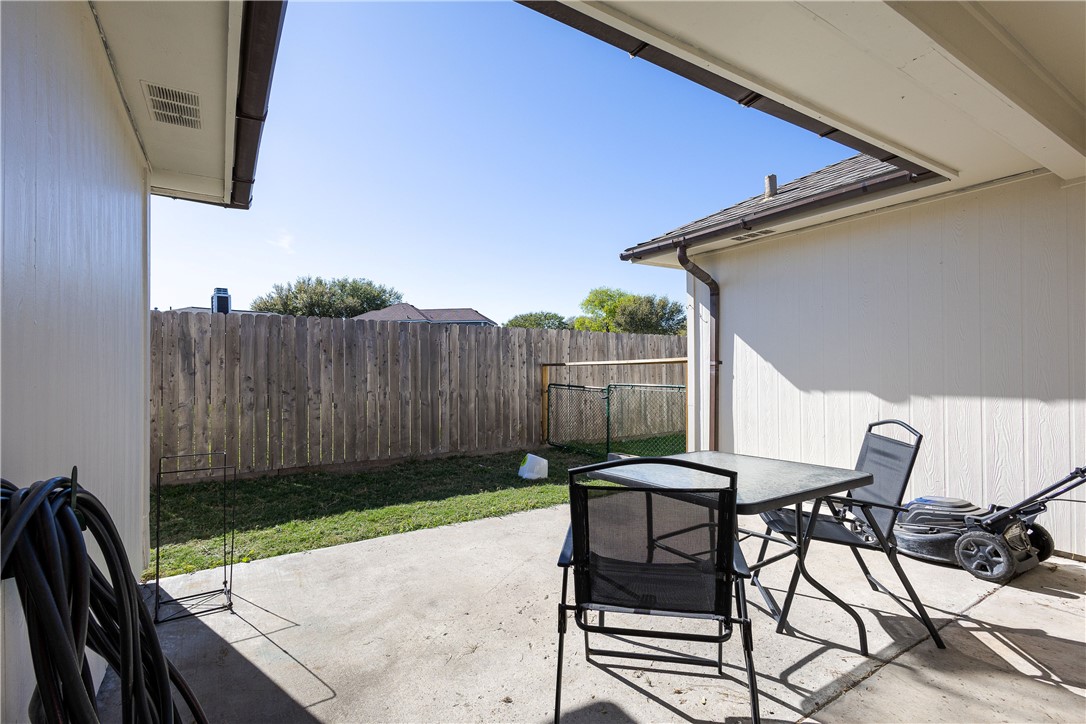 2839 Mckinzie Road, Unit 4 Corpus Christi, TX 78410 - Photo 28 of 31 a view of a backyard with table and chairs with wooden fence